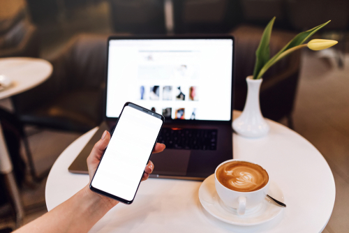 Lending Questions. Person on a phone and computer drinking fresh coffee